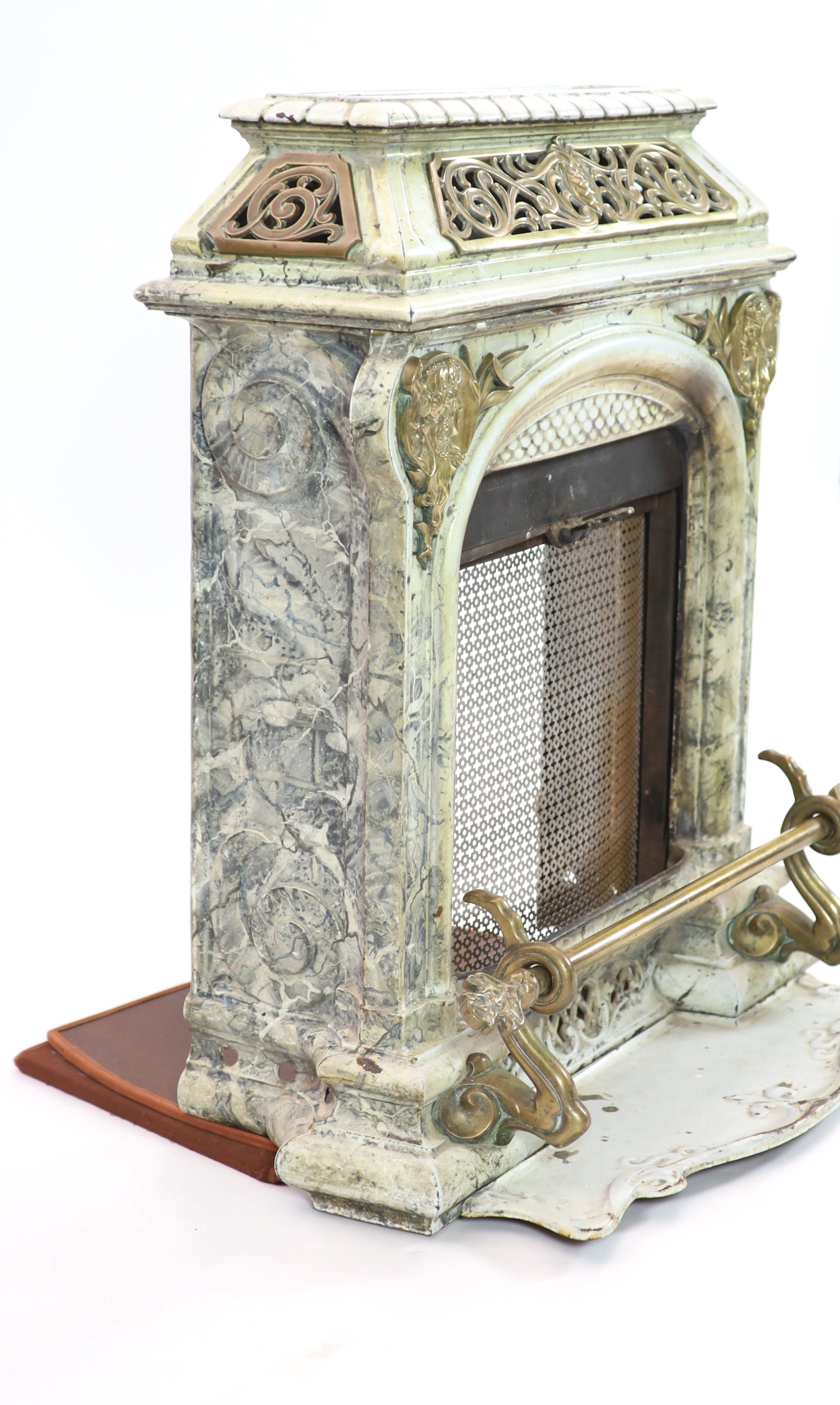 A late 19th century French Art Nouveau enamelled cast iron and brass fire surround H 91cm. W 82cm. D 46cm.